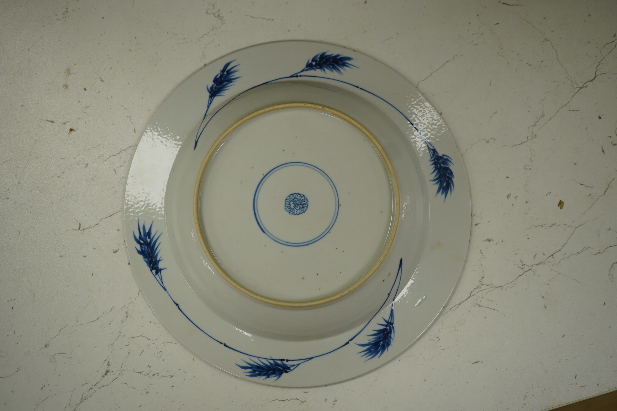 A Chinese powder blue plate, possibly Kangxi, with figurative central decoration, 22.5cm diameter. Condition - good